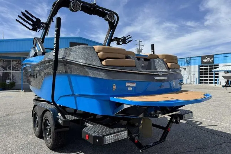 Slide: The Image of 2022 MasterCraft XT22 boat in blue, parked on a trailer outside a dealership. - 4