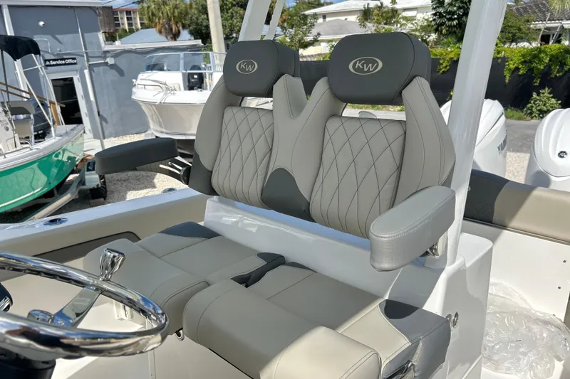 Slide: The Image of 2026 Key West 260 Center Console boat with luxurious seating and modern steering wheel. - 12