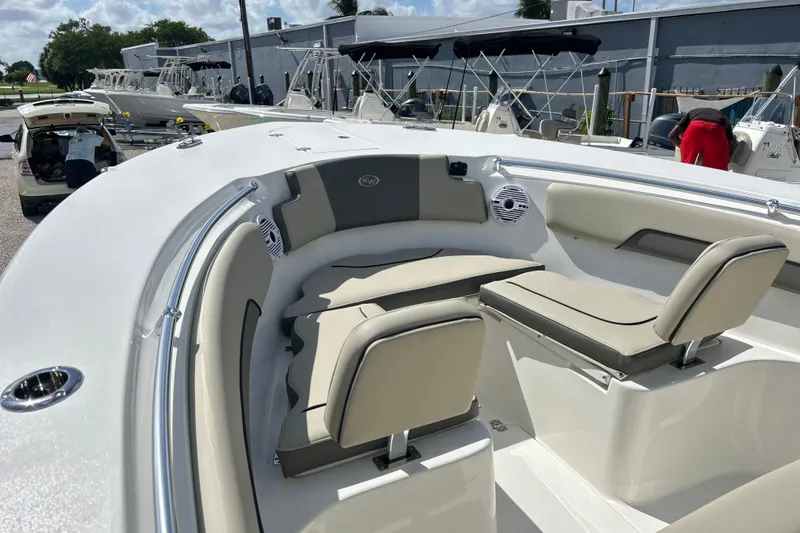 Slide: The Image of 2026 Key West 260 Center Console boat with beige seating and sleek design. - 2
