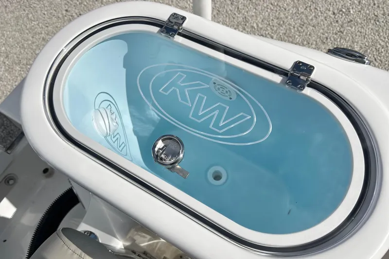 Slide: The Image of 2026 Key West 260 Center Console livewell with KW logo and secure latch. - 21