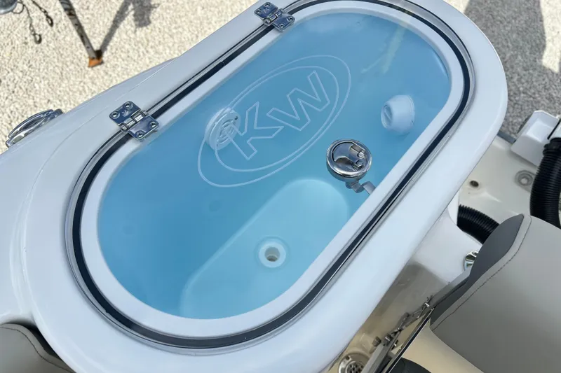 Slide: The Image of Livewell on 2026 Key West 260 Center Console boat, featuring KW logo and secure latch. - 24