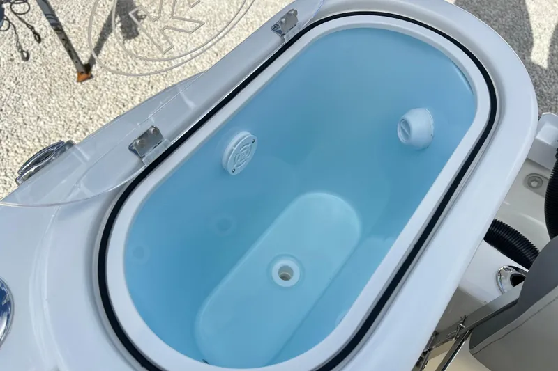 Slide: The Image of Livewell on 2026 Key West 260 Center Console boat, open lid, blue interior. - 26