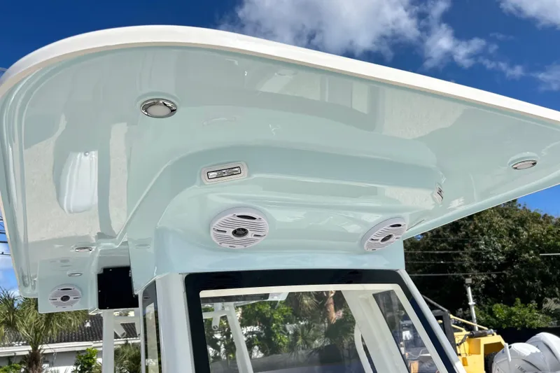 Slide: The Image of 2026 Key West 260 Center Console boat with sleek T-top and integrated speakers. - 27