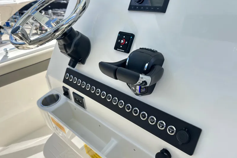 Slide: The Image of 2026 Key West 260 Center Console boat dashboard with steering wheel and controls. - 28