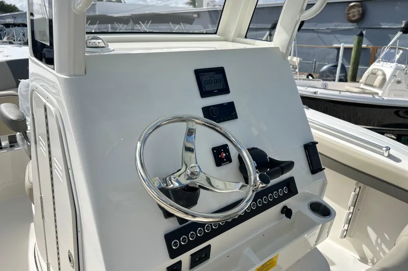 Slide: The Image of 2026 Key West 260 Center Console boat dashboard with steering wheel and controls. - 34