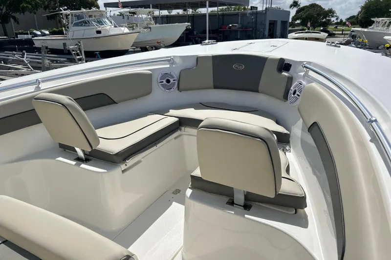 Slide: The Image of 2026 Key West 260 Center Console boat interior with cushioned seating and speakers. - 4