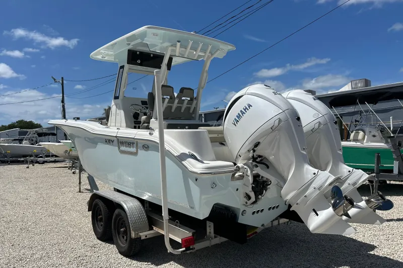 Slide: The Image of 2026 Key West 260 Center Console boat with dual Yamaha engines on a trailer. - 41