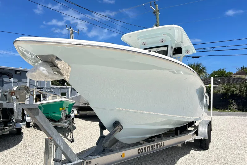 Slide: The Image of 2026 Key West 260 Center Console boat on trailer under clear blue sky. - 43