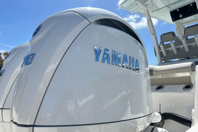 Slide: The Image of Yamaha engine on 2026 Key West 260 Center Console boat under clear blue sky. - 49