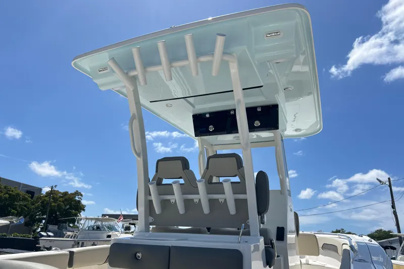 Slide: The Image of 2026 Key West 260 Center Console boat with T-top under clear blue sky. - 51