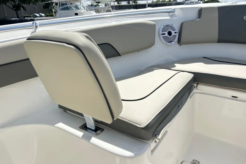 Slide: The Image of 2026 Key West 260 Center Console boat interior with cushioned seating and speaker. - 6
