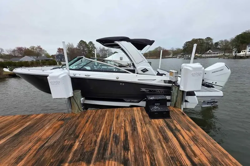 Slide: The Image of 2024 Monterey 275SS Super Sport boat docked on a wooden pier by the water. - 1
