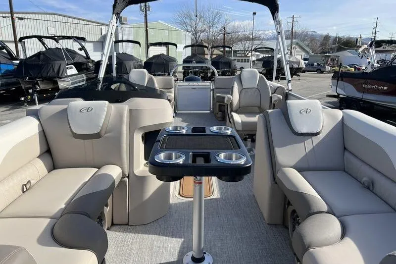 Slide: The Image of 2023 Avalon 2385 25 LSZ QL pontoon boat interior with luxurious seating and cup holders. - 11