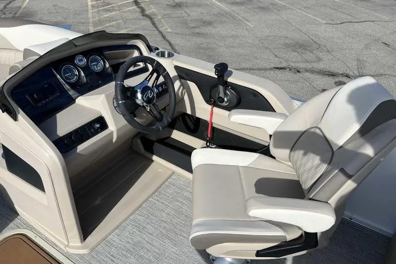 Slide: The Image of 2023 Avalon 2385 25 LSZ QL boat cockpit with steering wheel and captain's chair. - 13