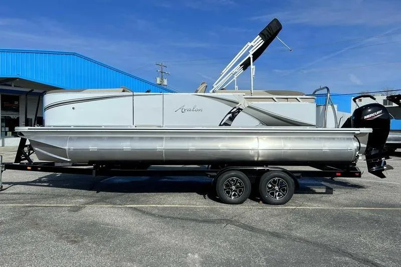 Slide: The Image of 2023 Avalon 2385 25 LSZ QL pontoon boat on trailer, parked outdoors. - 4