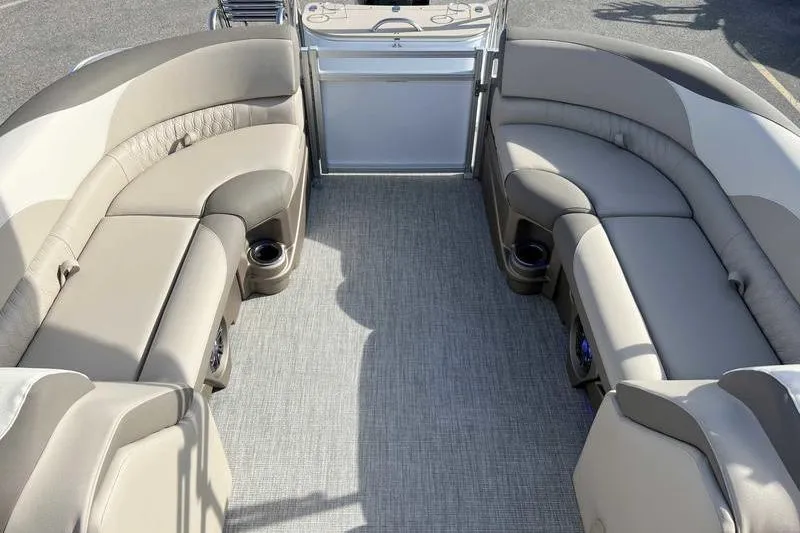 Slide: The Image of 2023 Avalon 2385 25 LSZ QL pontoon boat interior with plush seating and cup holders. - 7