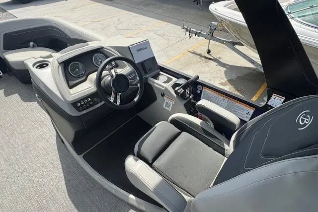 Slide: The Image of 2026 Barletta Cabrio 24UE boat cockpit with modern controls and comfortable seating. - 12