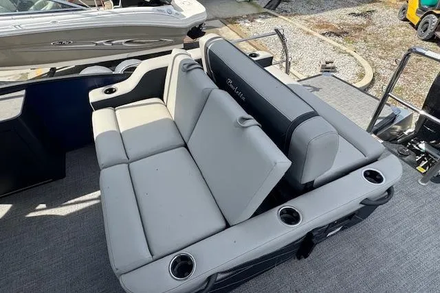 Slide: The Image of 2026 Barletta Cabrio 24UE boat interior with gray seating and cup holders. - 18