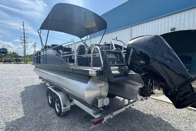 Slide: The Image of 2026 Barletta Cabrio 24UE pontoon boat on trailer, featuring a sleek design and powerful outboard motor. - 5