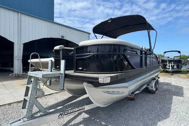 Slide: The Image of 2026 Barletta Cabrio 24UE pontoon boat on trailer, parked outdoors. - 8