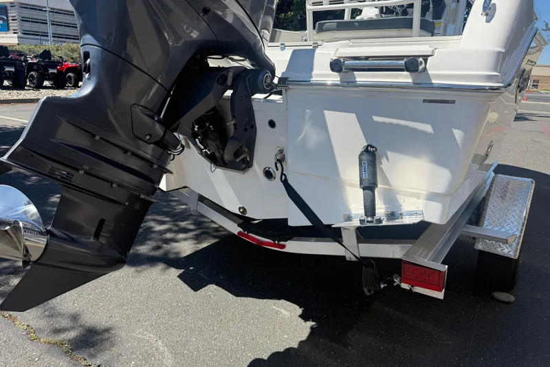 Slide: The Image of 2025 Robalo R180 Center Console boat on trailer, featuring powerful outboard motor. - 11