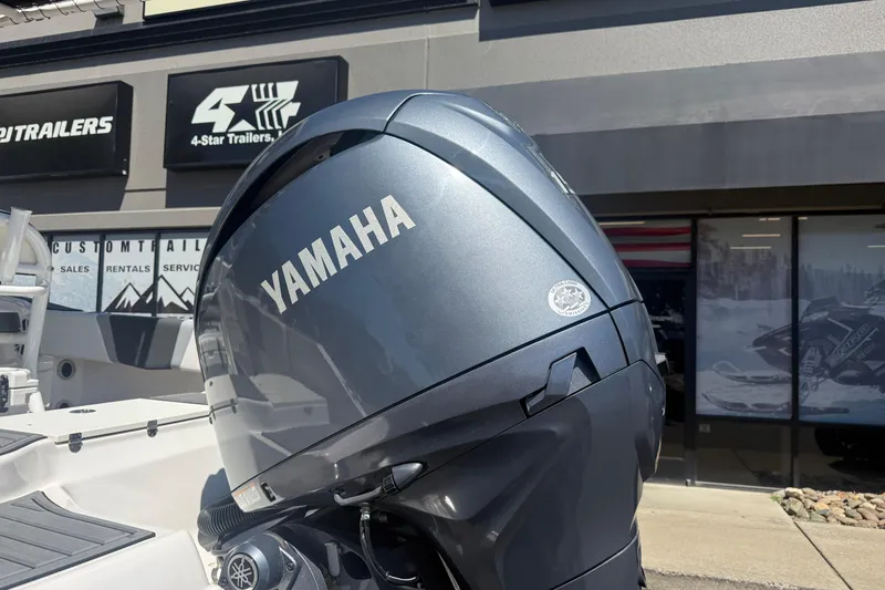 Slide: The Image of Yamaha outboard motor on 2025 Robalo R180 Center Console boat, dealership background. - 13