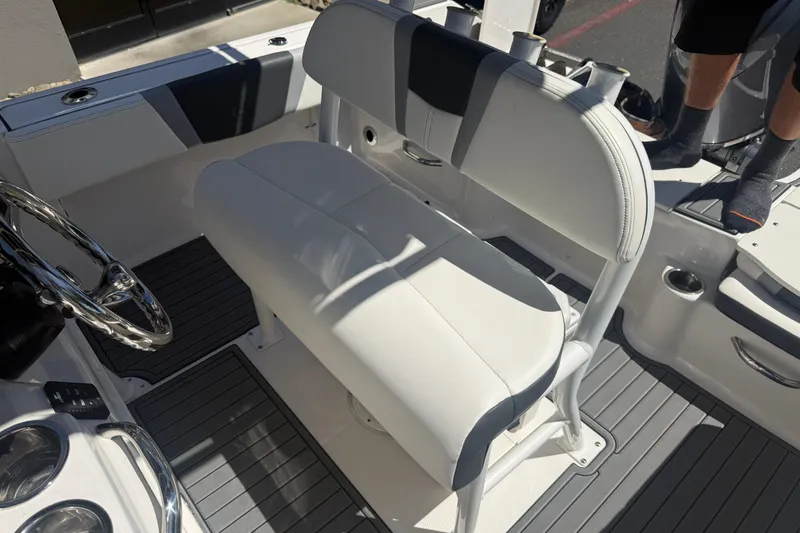 Slide: The Image of 2025 Robalo R180 Center Console boat interior with white seating and steering wheel. - 18