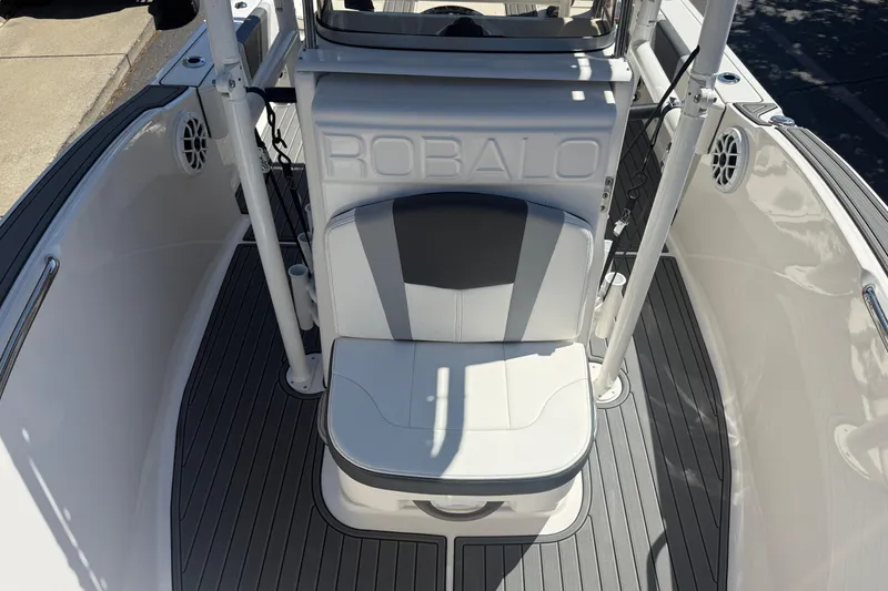 Slide: The Image of 2025 Robalo R180 Center Console boat interior with cushioned seating and sleek design. - 20