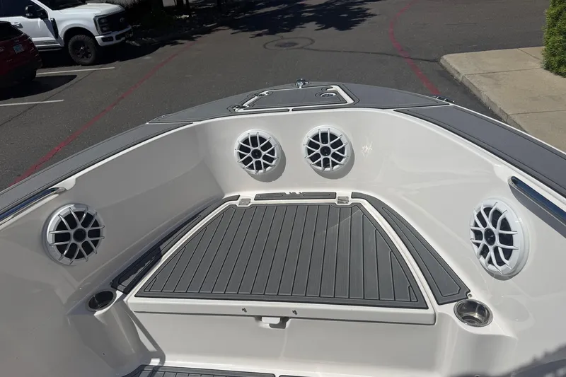 Slide: The Image of 2025 Robalo R180 Center Console boat interior with speakers and seating area. - 21