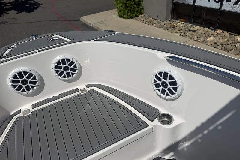 Slide: The Image of 2025 Robalo R180 Center Console boat with speakers and sleek deck design. - 23
