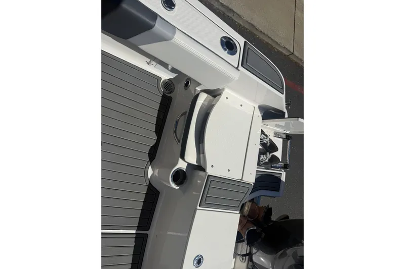Slide: The Image of 2025 Robalo R180 Center Console boat deck with seating and storage compartments. - 26
