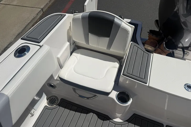 Slide: The Image of 2025 Robalo R180 Center Console boat seat with cup holders and storage compartments. - 27