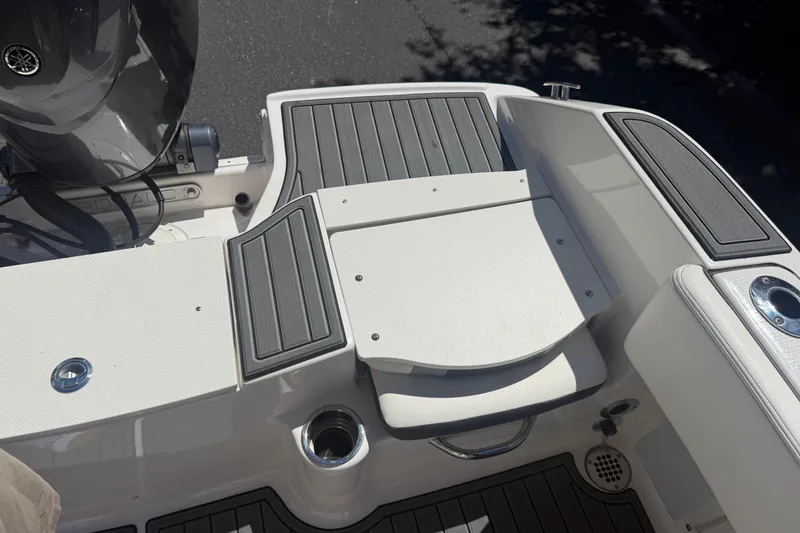 Slide: The Image of 2025 Robalo R180 Center Console boat deck with seating and motor detail. - 29