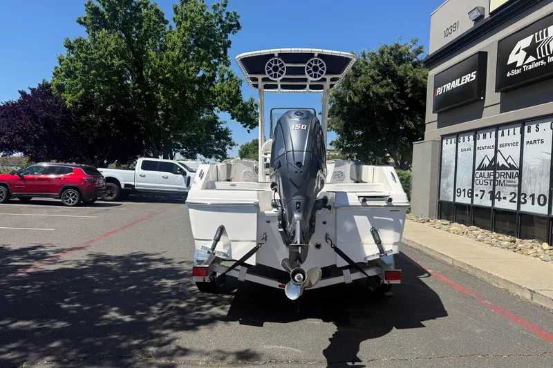 Slide: The Image of 2025 Robalo R180 Center Console boat with outboard motor in parking lot. - 3