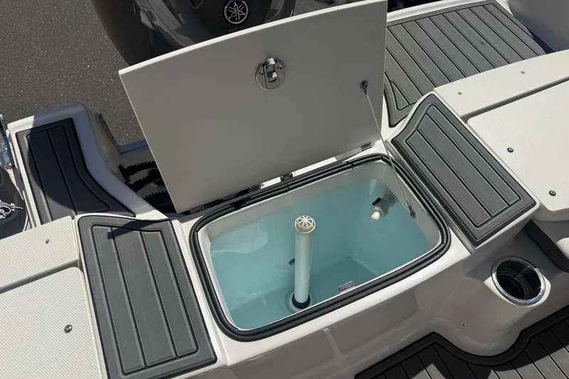 Slide: The Image of 2025 Robalo R180 Center Console boat with open storage compartment. - 37