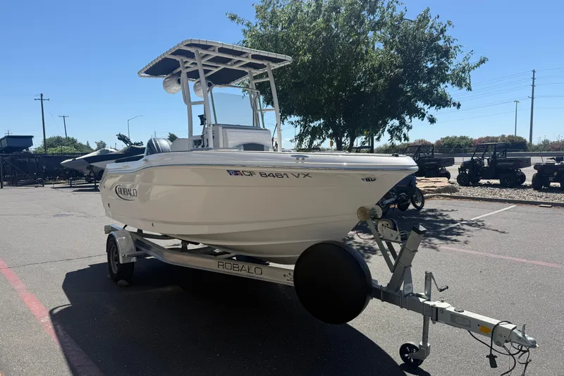 Slide: The Image of 2025 Robalo R180 Center Console boat on trailer in parking lot. - 5