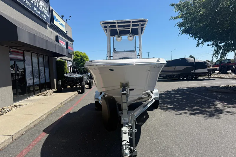 Slide: The Image of 2025 Robalo R180 Center Console boat on trailer outside dealership. - 6