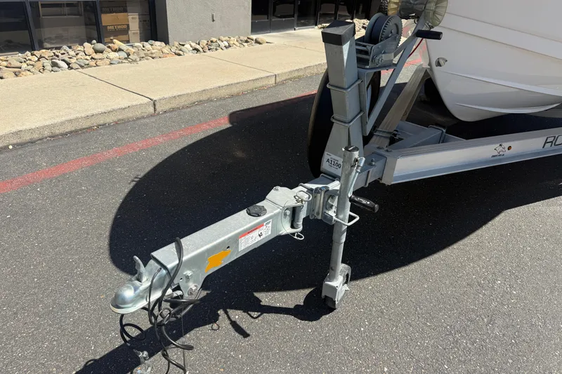 Slide: The Image of Trailer hitch of 2025 Robalo R180 Center Console boat on pavement. - 7