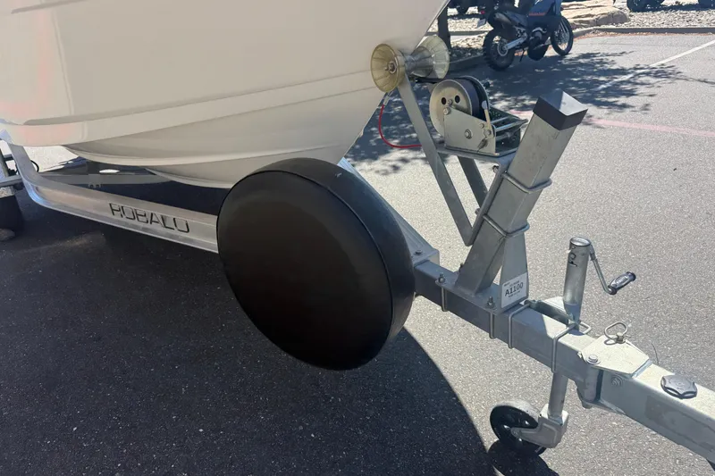 Slide: The Image of 2025 Robalo R180 Center Console boat on trailer, parked outdoors. - 8