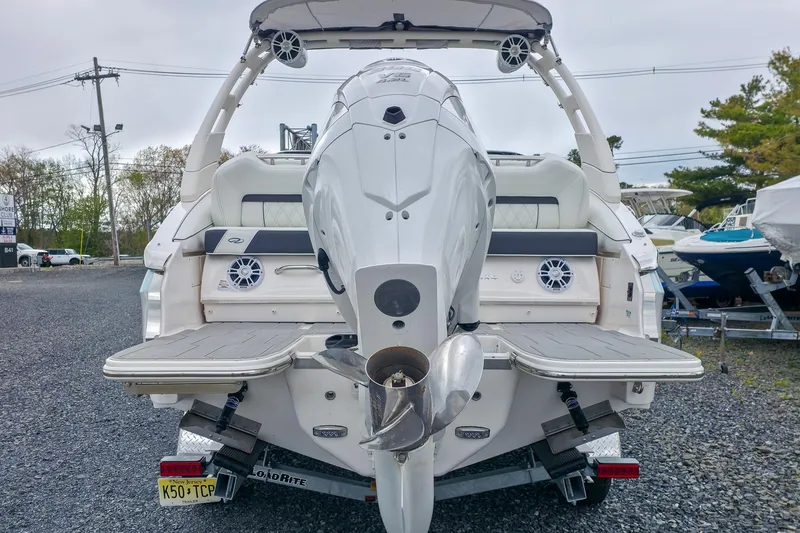 Slide: The Image of Rear view of a 2025 Regal LX4 boat with outboard motor and swim platform. - 12
