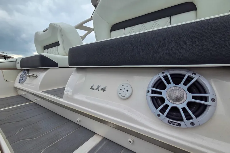 Slide: The Image of 2025 Regal LX4 boat interior with premium seating and integrated Fusion speakers. - 13