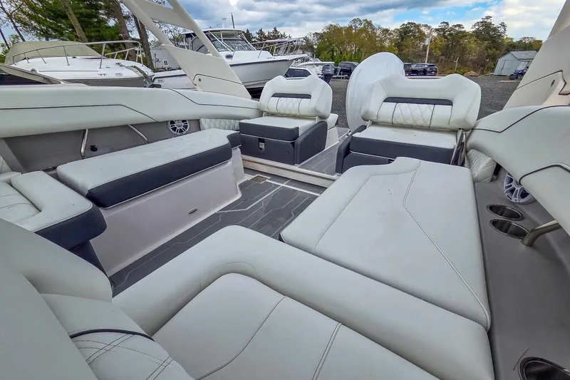 Slide: The Image of Luxurious seating area on a 2025 Regal LX4 boat, featuring elegant white upholstery. - 19
