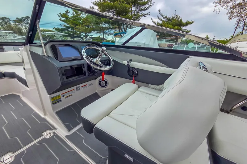 Slide: The Image of 2025 Regal LX4 boat interior with modern dashboard and steering wheel. - 20