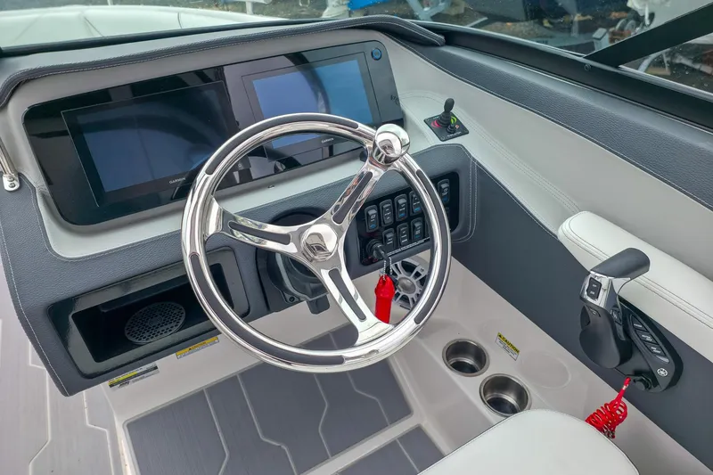 Slide: The Image of 2025 Regal LX4 boat dashboard with steering wheel, digital displays, and control panel. - 22