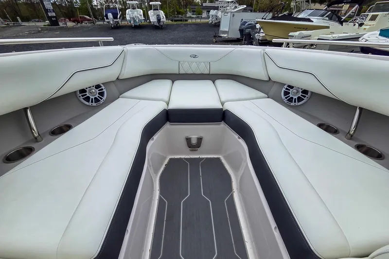 Slide: The Image of Interior of 2025 Regal LX4 boat with white seating and cup holders. - 25