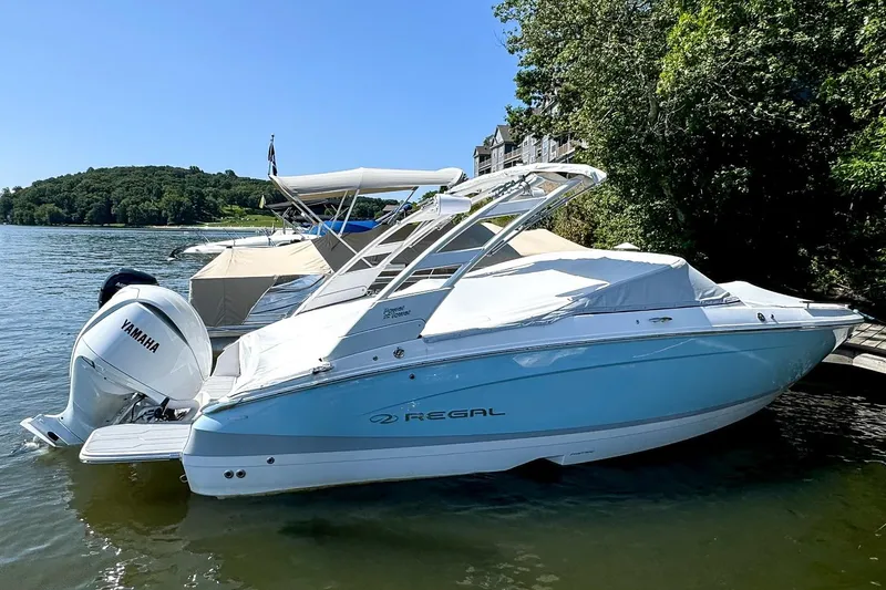 Slide: The Image of 2025 Regal LX4 boat with Yamaha engine docked by a scenic lakeside. - 3