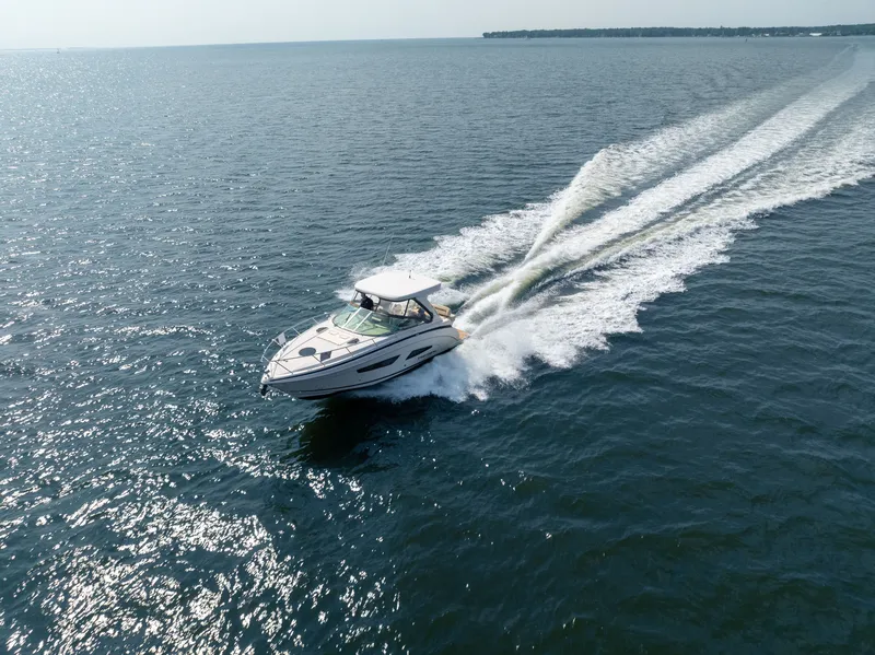 Slide: The Image of A 2019 Regal 33 Express speeds across the open sea. - 2