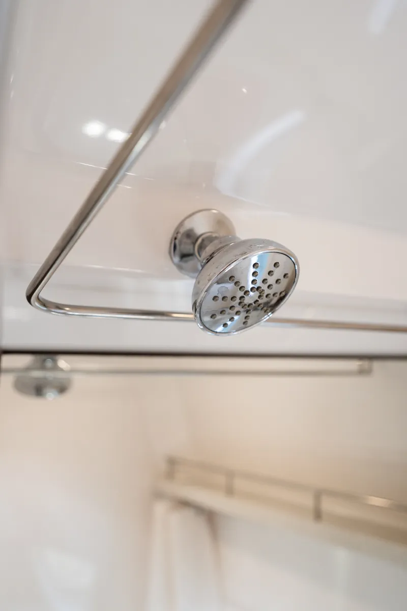 Slide: The Image of Close-up of a showerhead in a modern bathroom. - 29