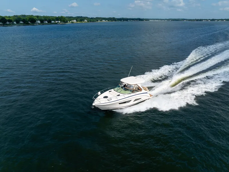 Slide: The Image of A 2019 Regal 33 Express speeds across the water, surrounded by a vast water landscape. - 4