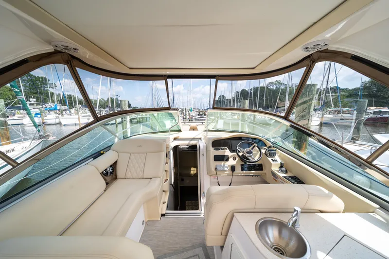 Slide: The Image of Interior view of a 2019 Regal 33 Express with beige seating and helm station. - 43